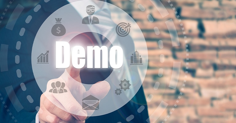 Businessman pressing a virtual button labeled “Demo” with various marketing icons surrounding it.